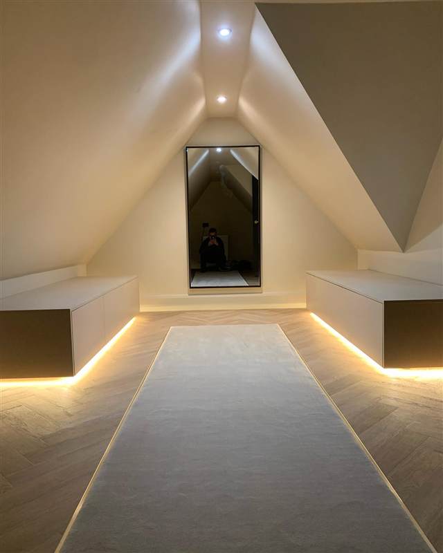 LED-lit loft dressing room with floating drawers and a full-length mirror